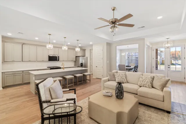a living room with furniture and kitchen view