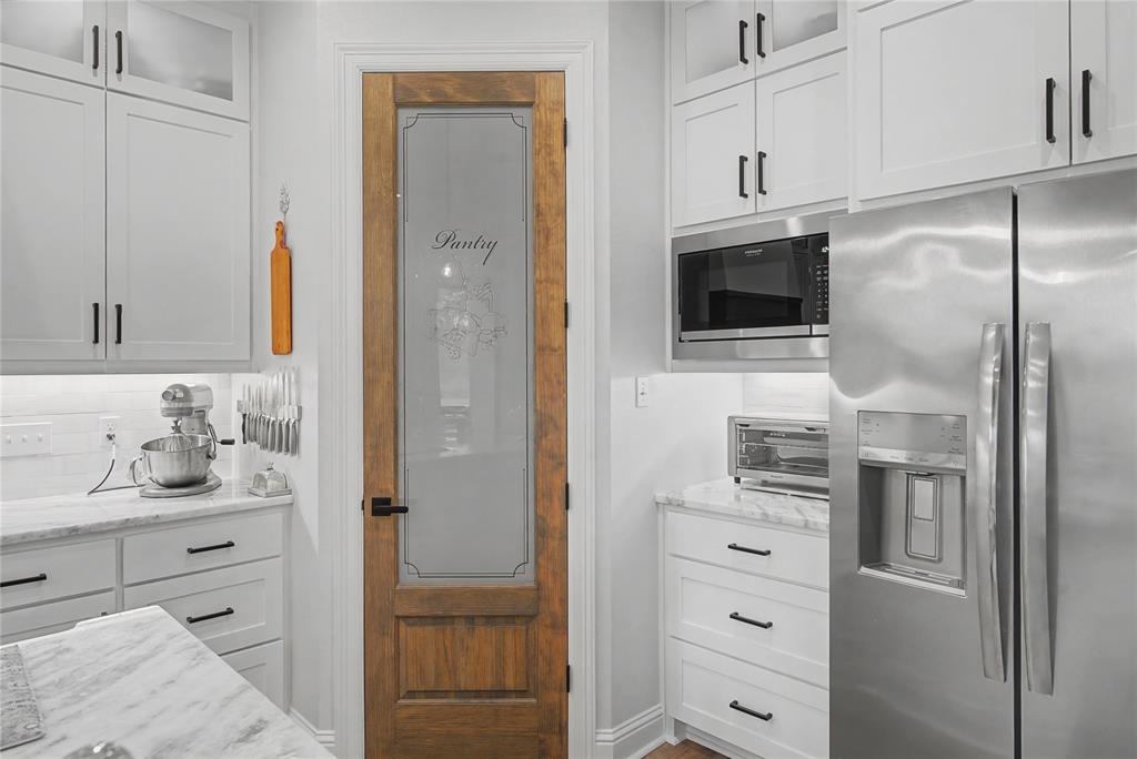 347 Ridge Drive Stonewall, LA 71078 - Photo 13 of 39 a kitchen with a refrigerator and cabinets