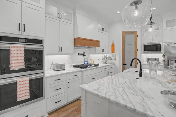 a kitchen with a sink stove and cabinets