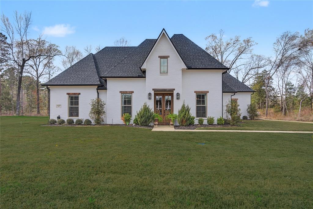 347 Ridge Drive Stonewall, LA 71078 - Photo 2 of 39 a front view of a house with a garden and yard