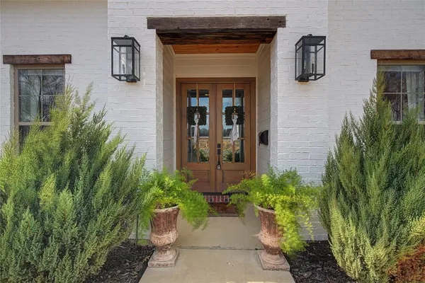 a front view of a house with potted plants