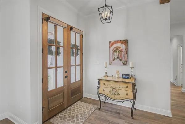 a view of a dining room with a table and chairs