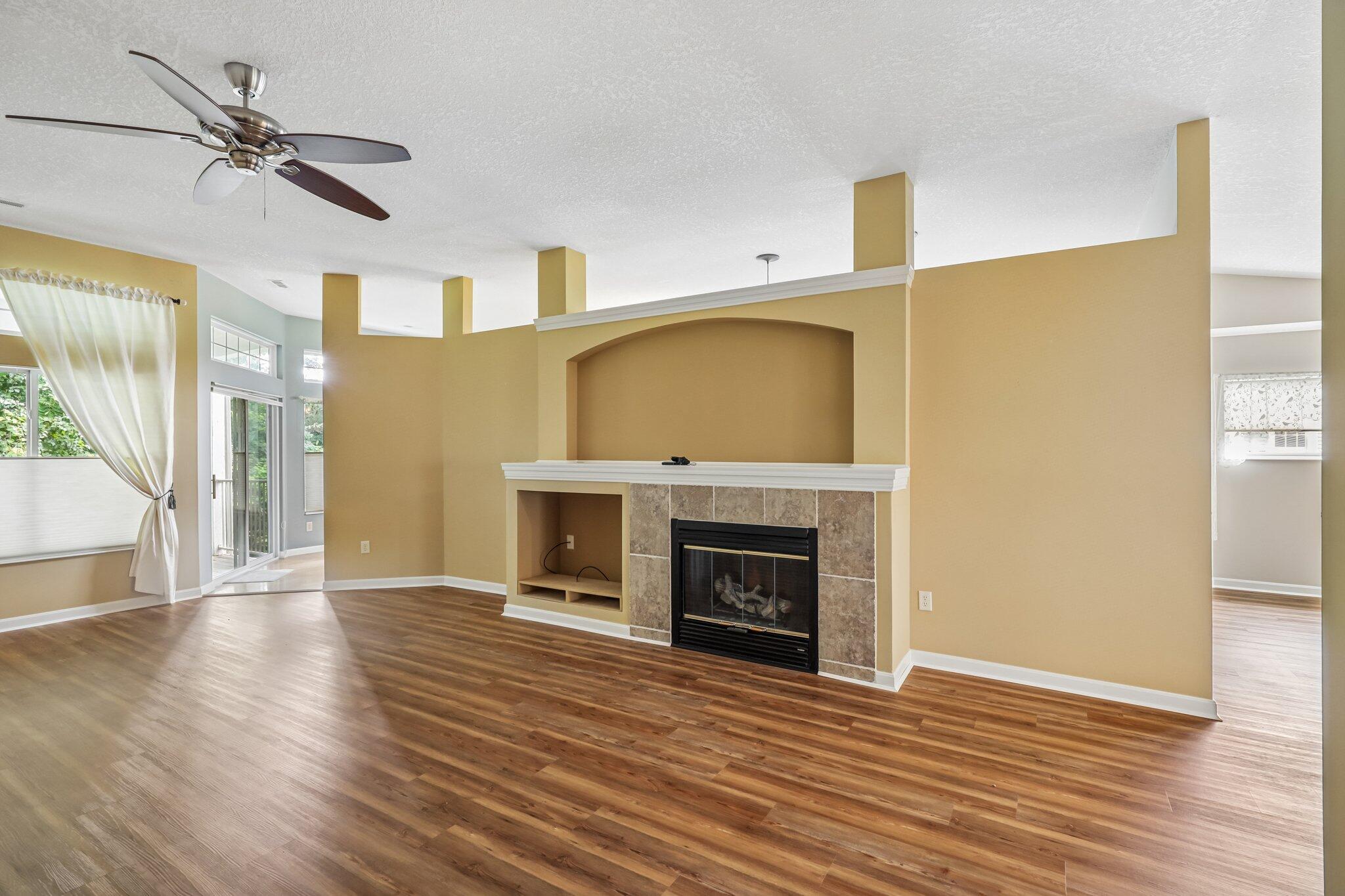 876 Flint Ridge Newport, KY 41076 - Photo 16 of 43 Living area featuring wood-finish flooring, a ceiling fan, and a fireplace with tile surround