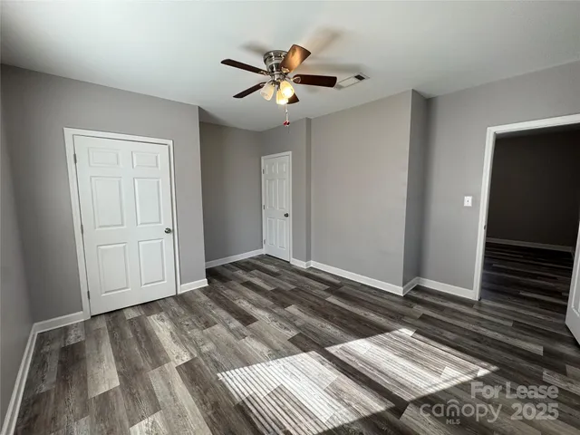 a bedroom with bed and ceiling fan