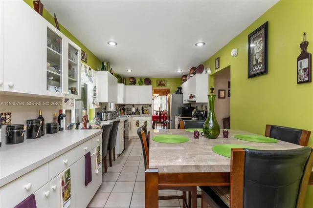 a kitchen with a sink stove top oven and cabinets