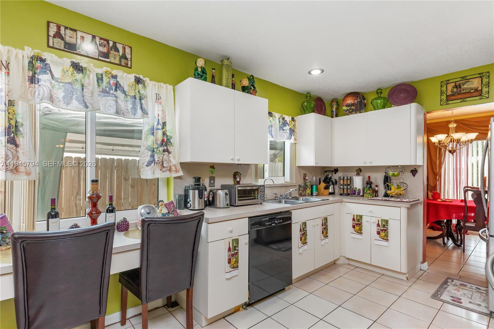 15244 Southwest 108th Court Miami, FL 33157 - Photo 15 of 47 a kitchen with a stove a refrigerator sink dishwasher and cabinets with wooden floor