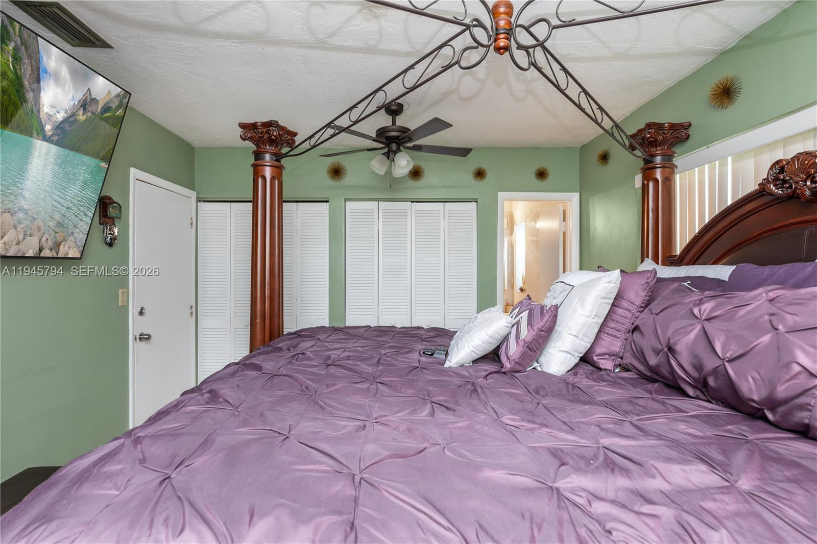 15244 Southwest 108th Court Miami, FL 33157 - Photo 19 of 47 a bedroom with a bed mirror and a chandelier