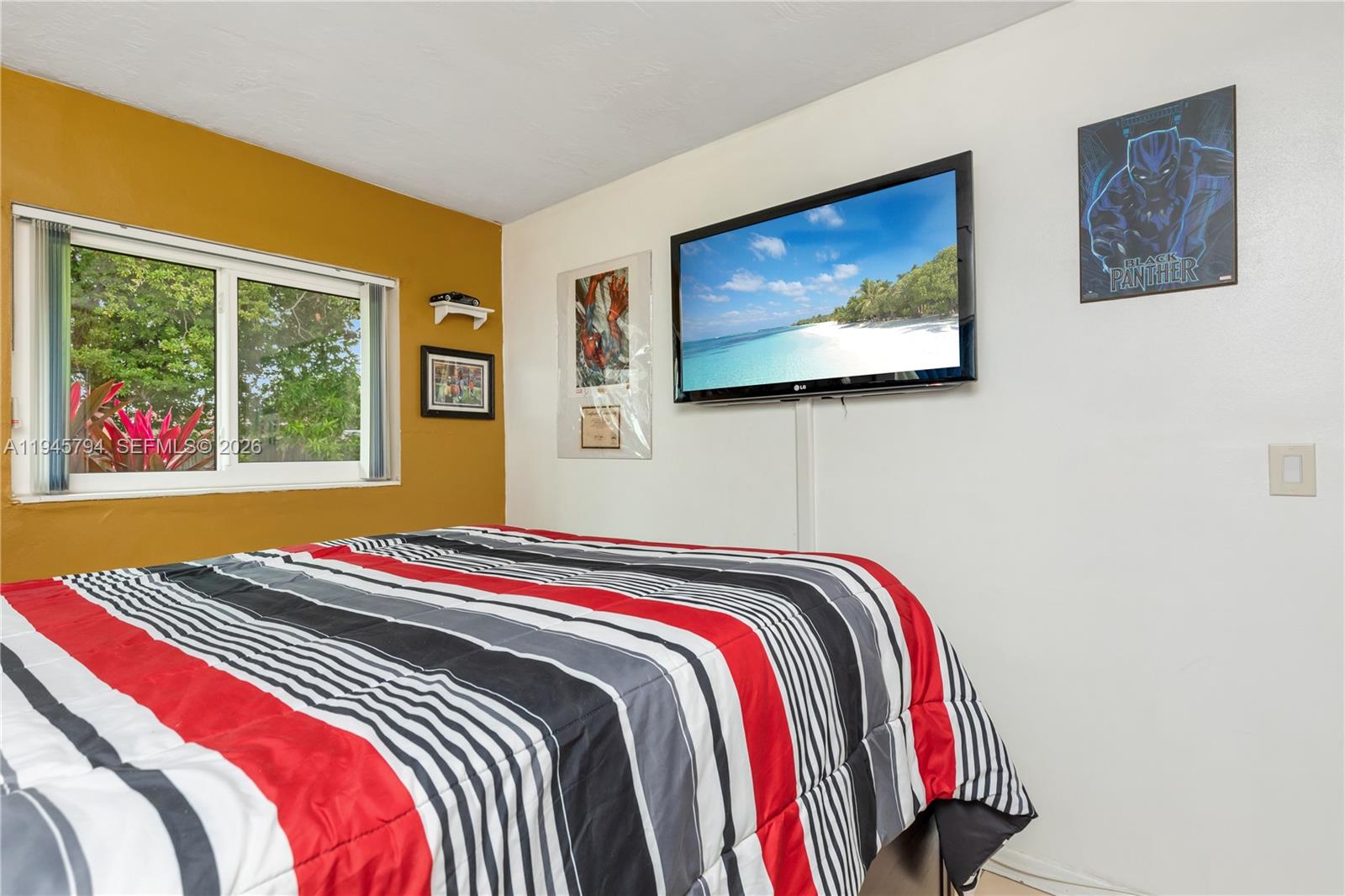 15244 Southwest 108th Court Miami, FL 33157 - Photo 27 of 47 a bed sitting in a bedroom next to a window