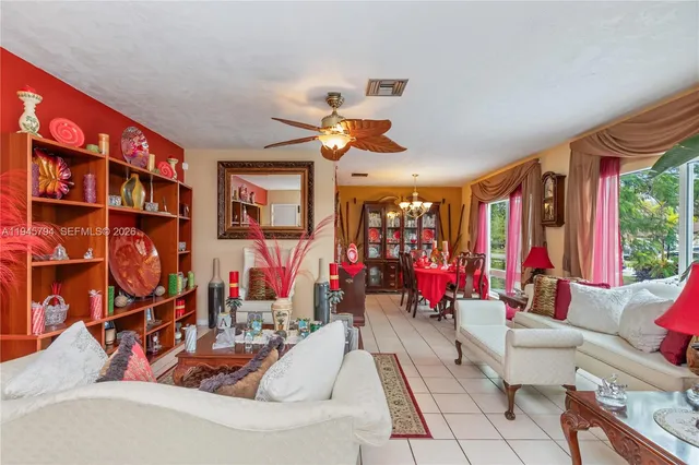 a living room with furniture gym equipment and a chandelier