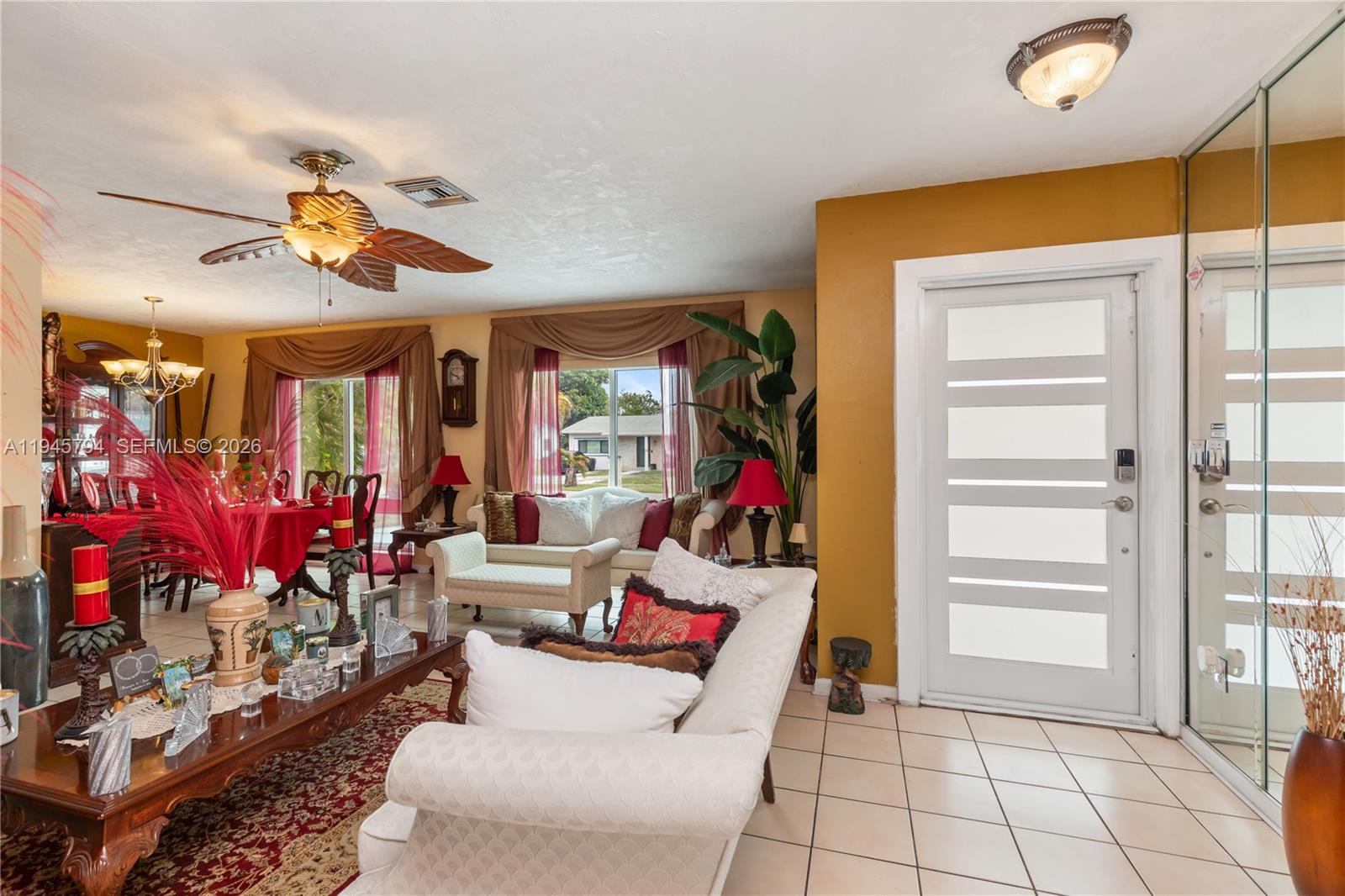 15244 Southwest 108th Court Miami, FL 33157 - Photo 33 of 47 a living room with furniture gym equipment and a chandelier