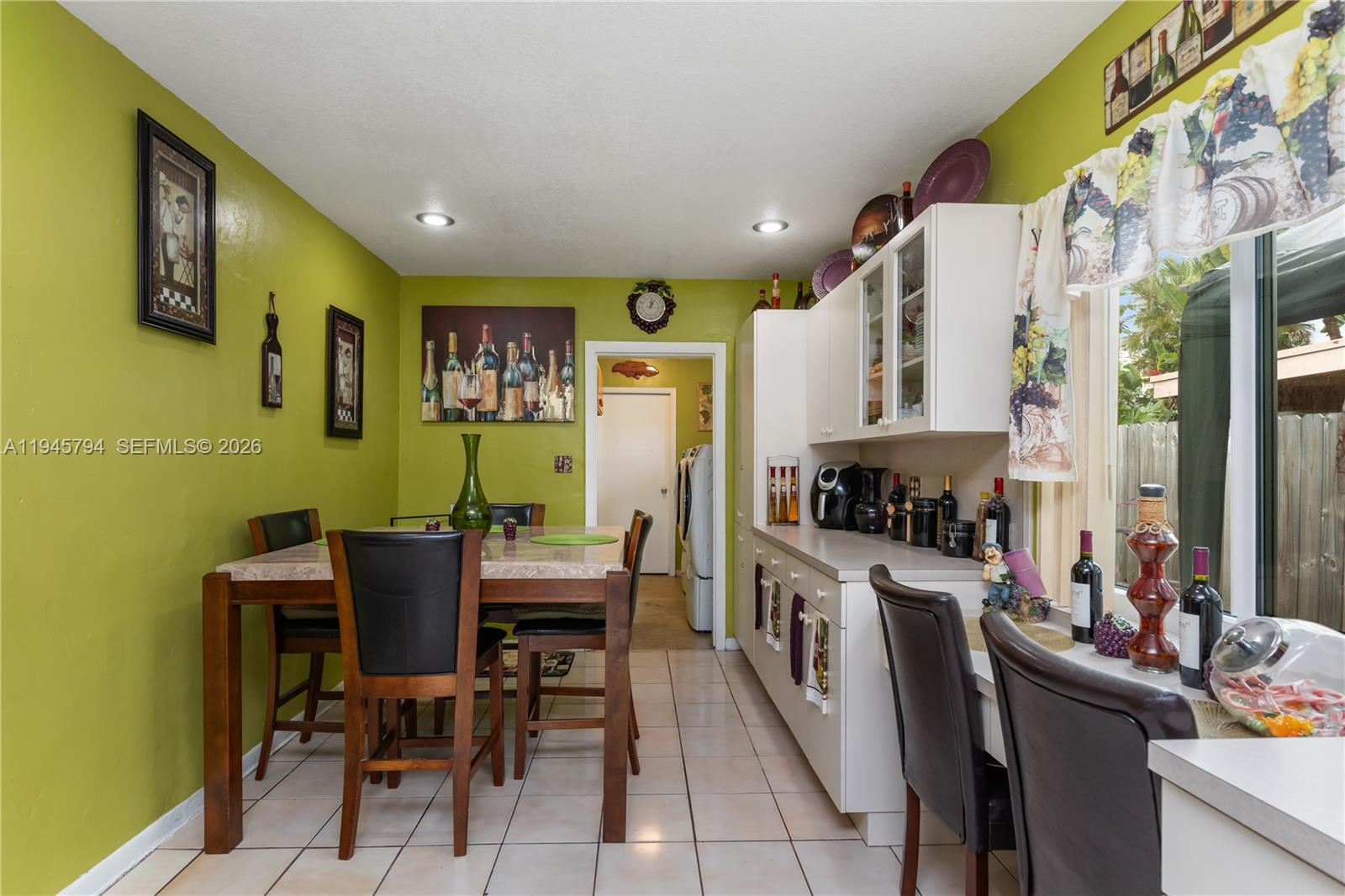 15244 Southwest 108th Court Miami, FL 33157 - Photo 10 of 47 a view of a dining room with furniture a kitchen and a window