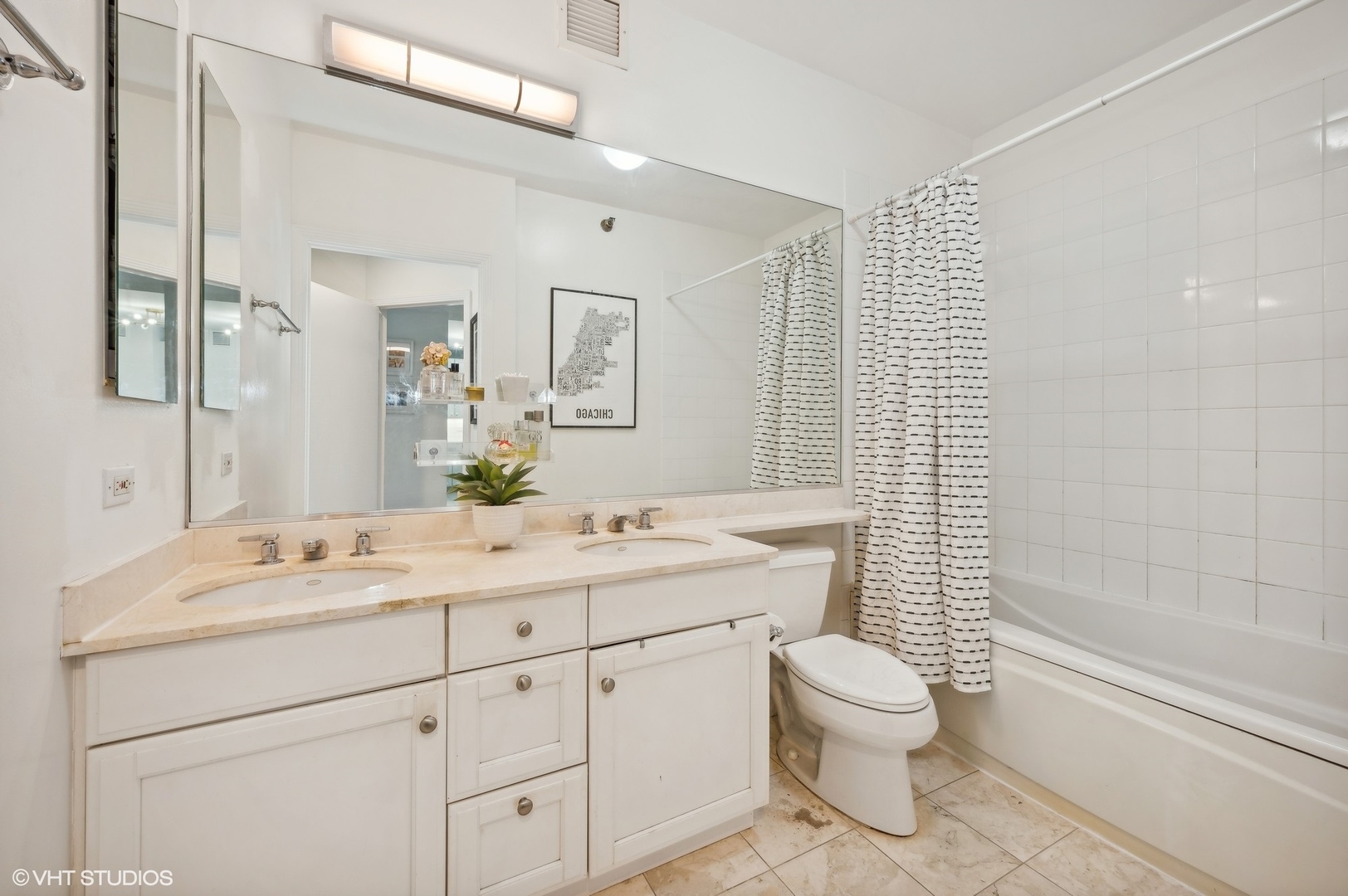 501 North Clinton Street, Unit 604 Chicago, IL 60654 - Photo 14 of 25 a bathroom with a double vanity sink toilet mirror and shower