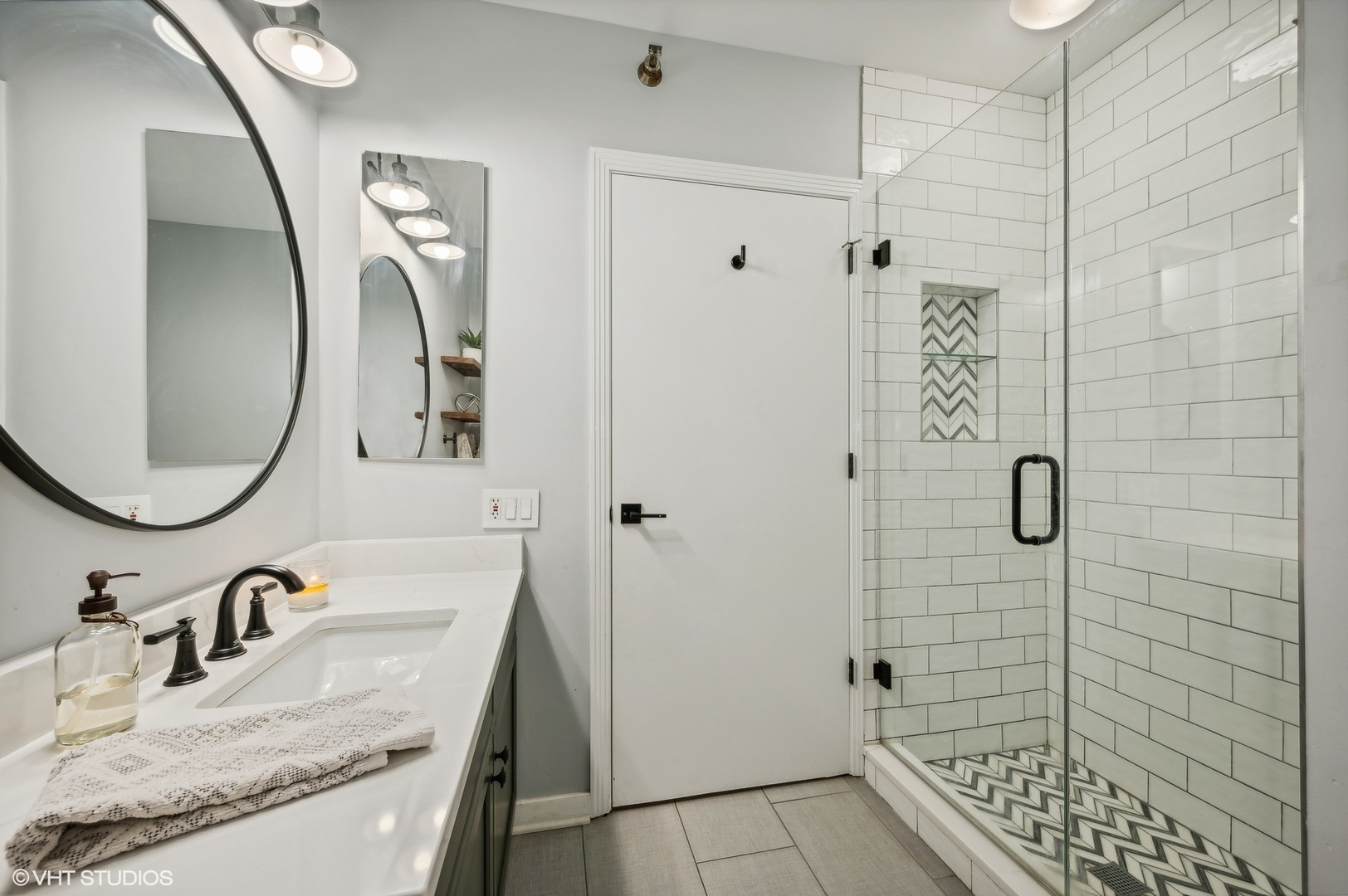501 North Clinton Street, Unit 604 Chicago, IL 60654 - Photo 18 of 25 a bathroom with a granite countertop sink a shower and mirror