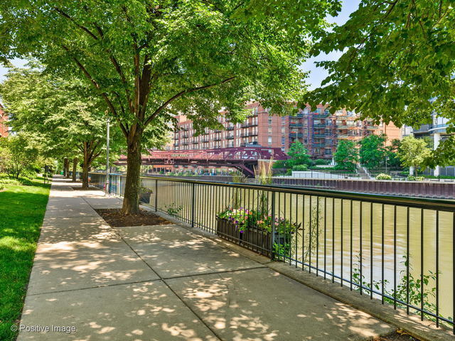 501 North Clinton Street, Unit 604 Chicago, IL 60654 - Photo 22 of 25 a balcony with trees in front of it