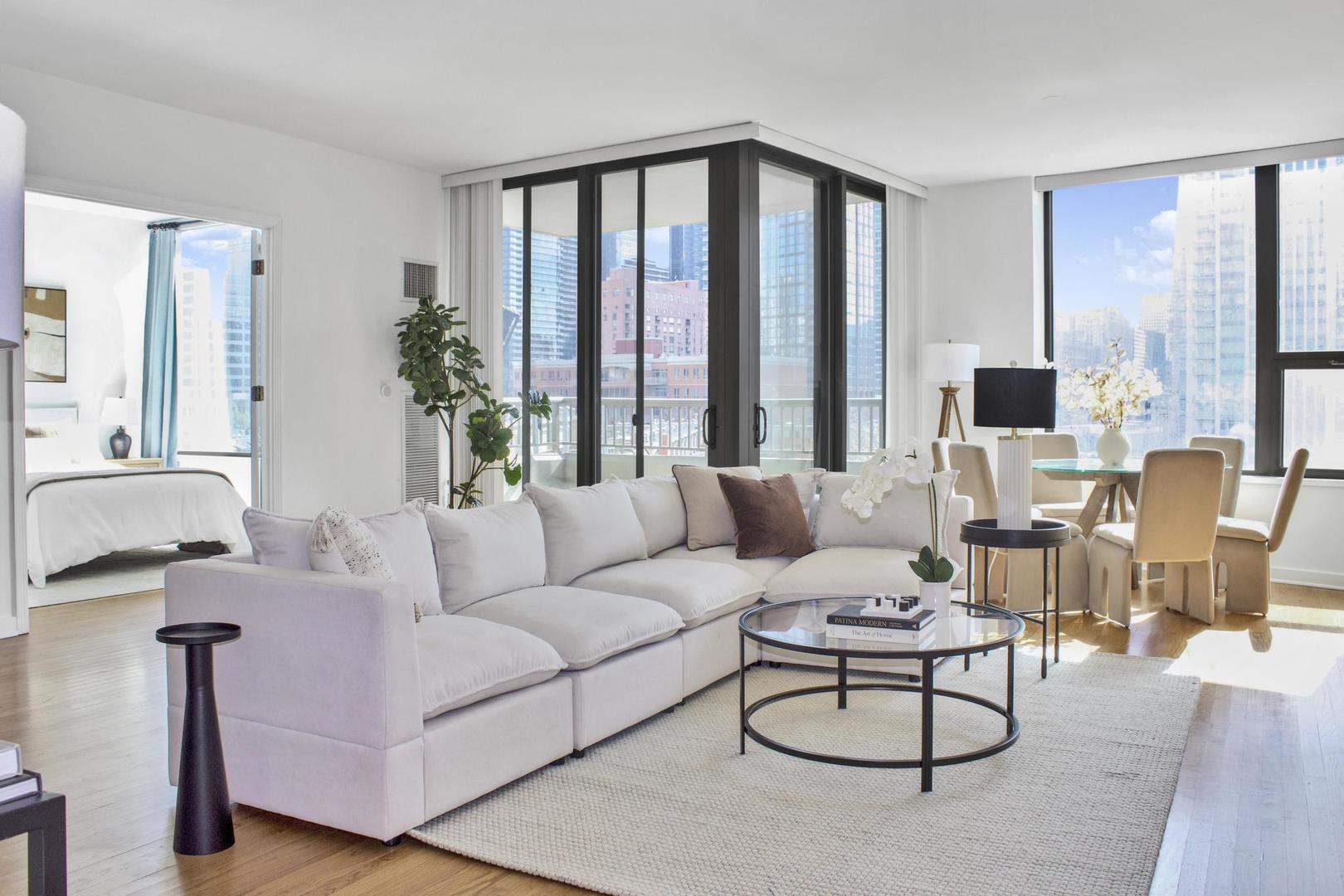 501 North Clinton Street, Unit 604 Chicago, IL 60654 - Photo 4 of 25 a living room with furniture and large windows