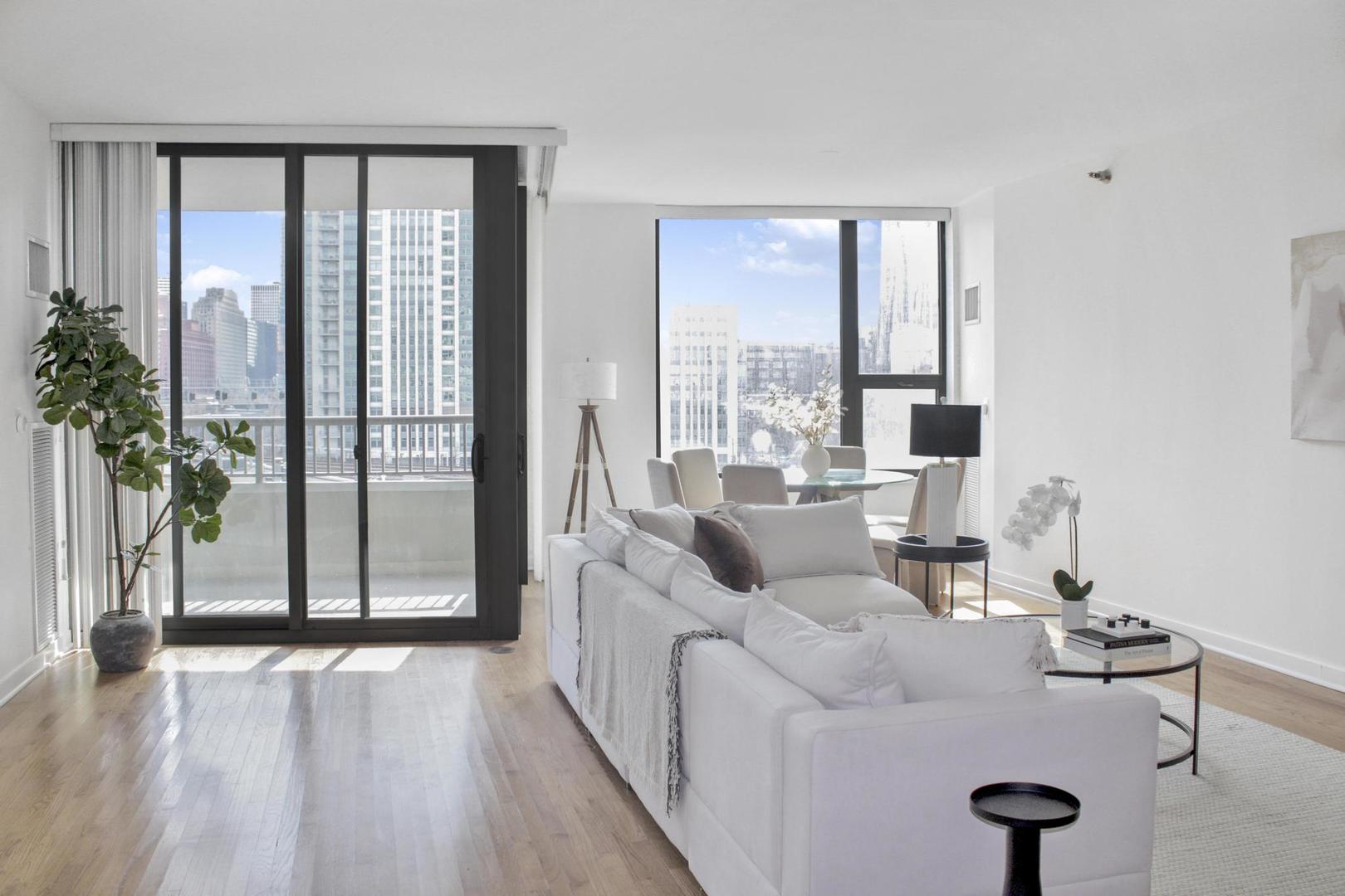 501 North Clinton Street, Unit 604 Chicago, IL 60654 - Photo 5 of 25 a living room with furniture and a large window