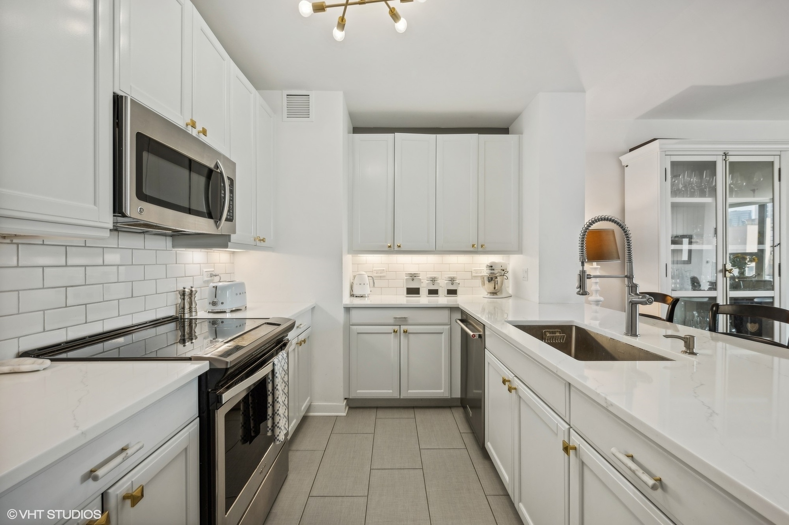 501 North Clinton Street, Unit 604 Chicago, IL 60654 - Photo 9 of 25 a kitchen with stainless steel appliances granite countertop a sink stove and microwave