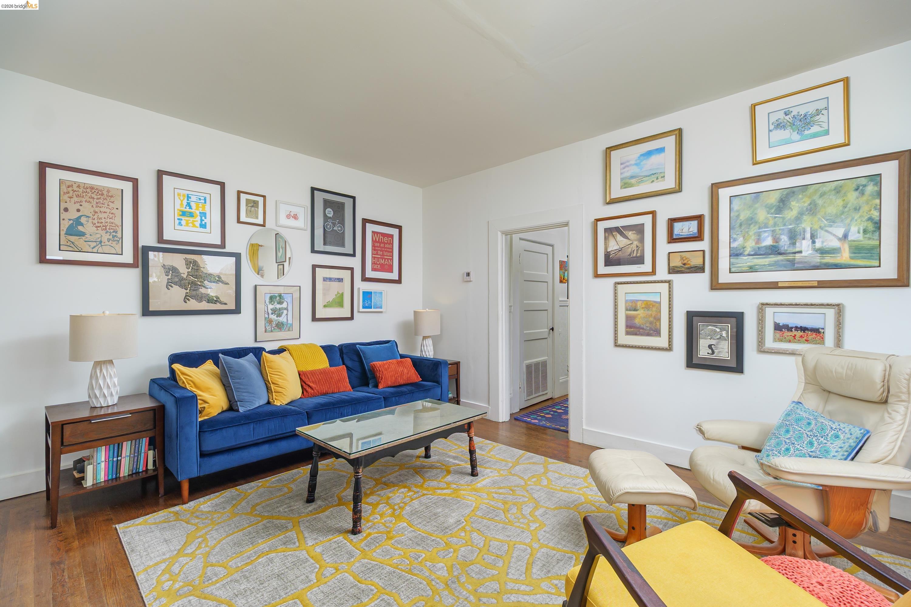 1735 Tenth Street Berkeley, CA 94710 - Photo 12 of 50 a living room with furniture a couch and paintings on the wall