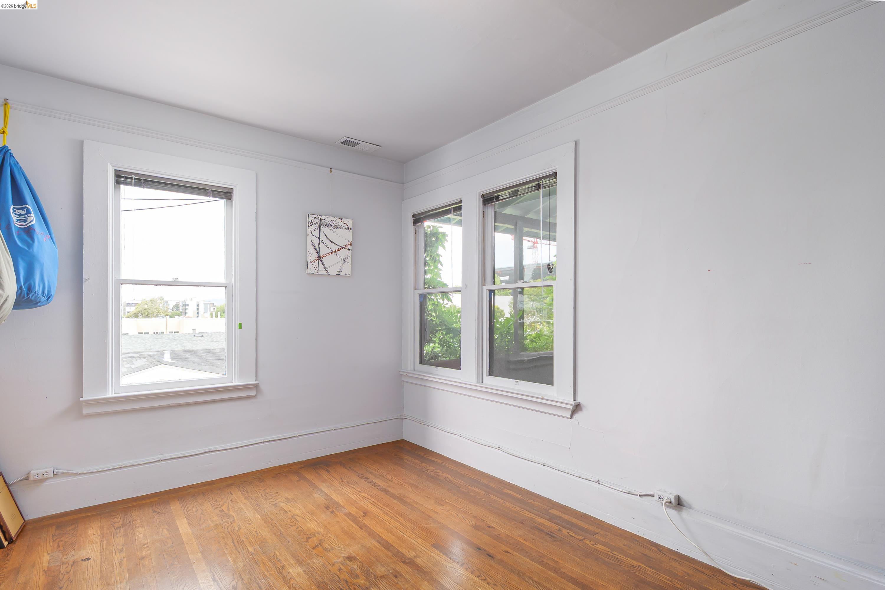 1735 Tenth Street Berkeley, CA 94710 - Photo 15 of 50 a view of an empty room with wooden floor and a window