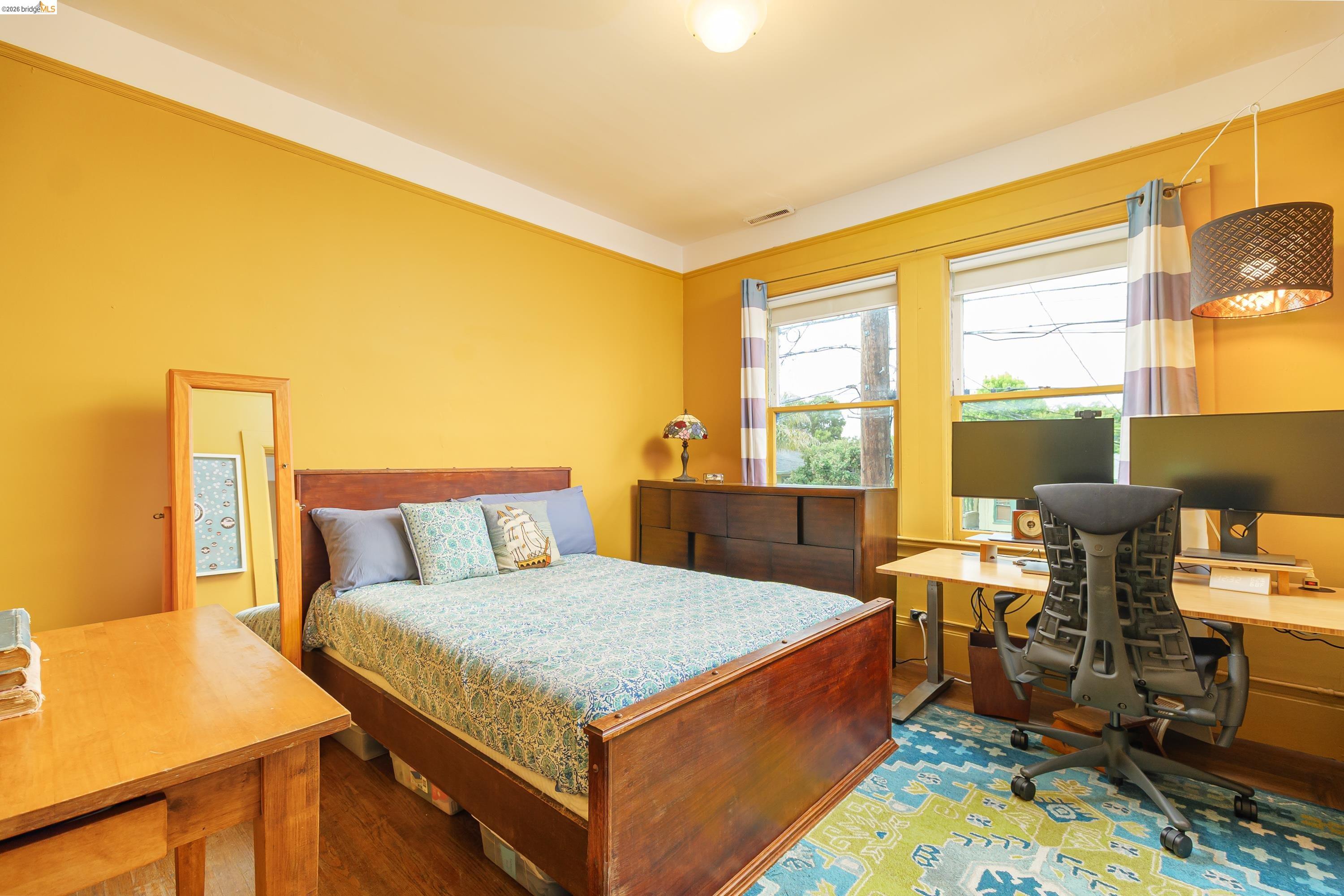 1735 Tenth Street Berkeley, CA 94710 - Photo 16 of 50 a bedroom with a bed and wooden floor