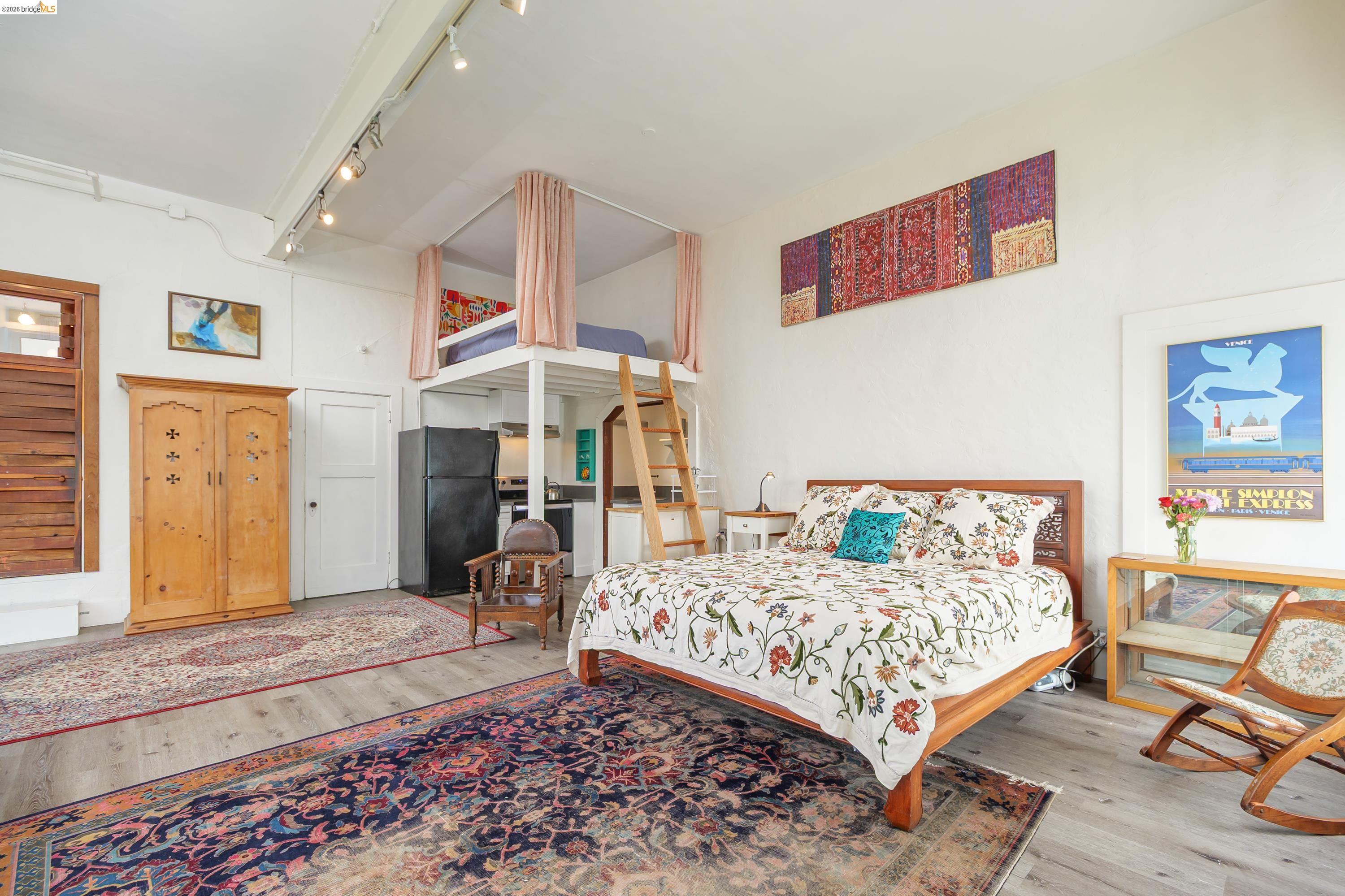 1735 Tenth Street Berkeley, CA 94710 - Photo 22 of 50 a bedroom with a bed and wooden floor