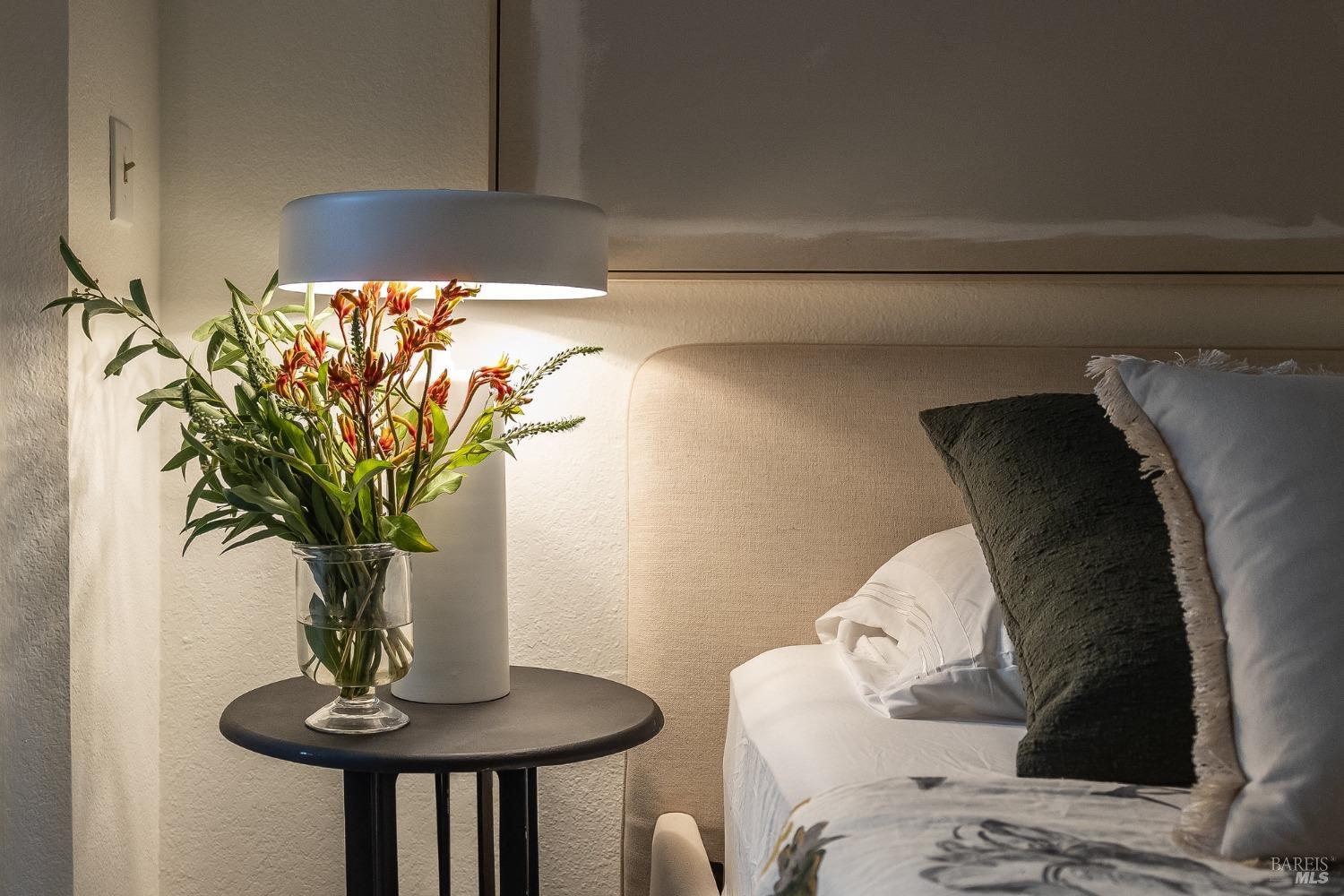 108 Stanford Way Sausalito, CA 94965 - Photo 26 of 43 a vase of flowers sitting on a table with a fireplace