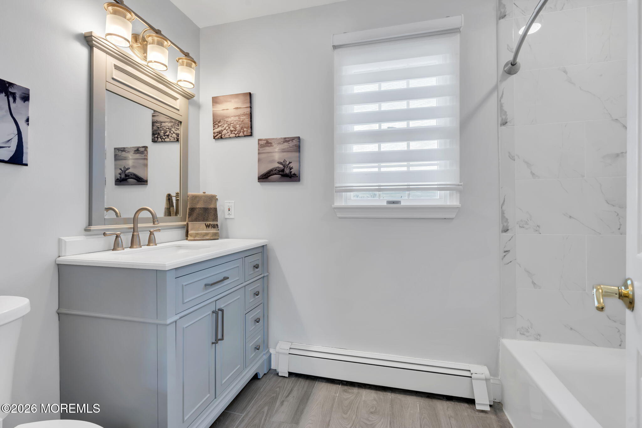83 Seawood Drive Keyport, NJ 07735 - Photo 12 of 23 a bathroom with a sink a mirror and a bathtub
