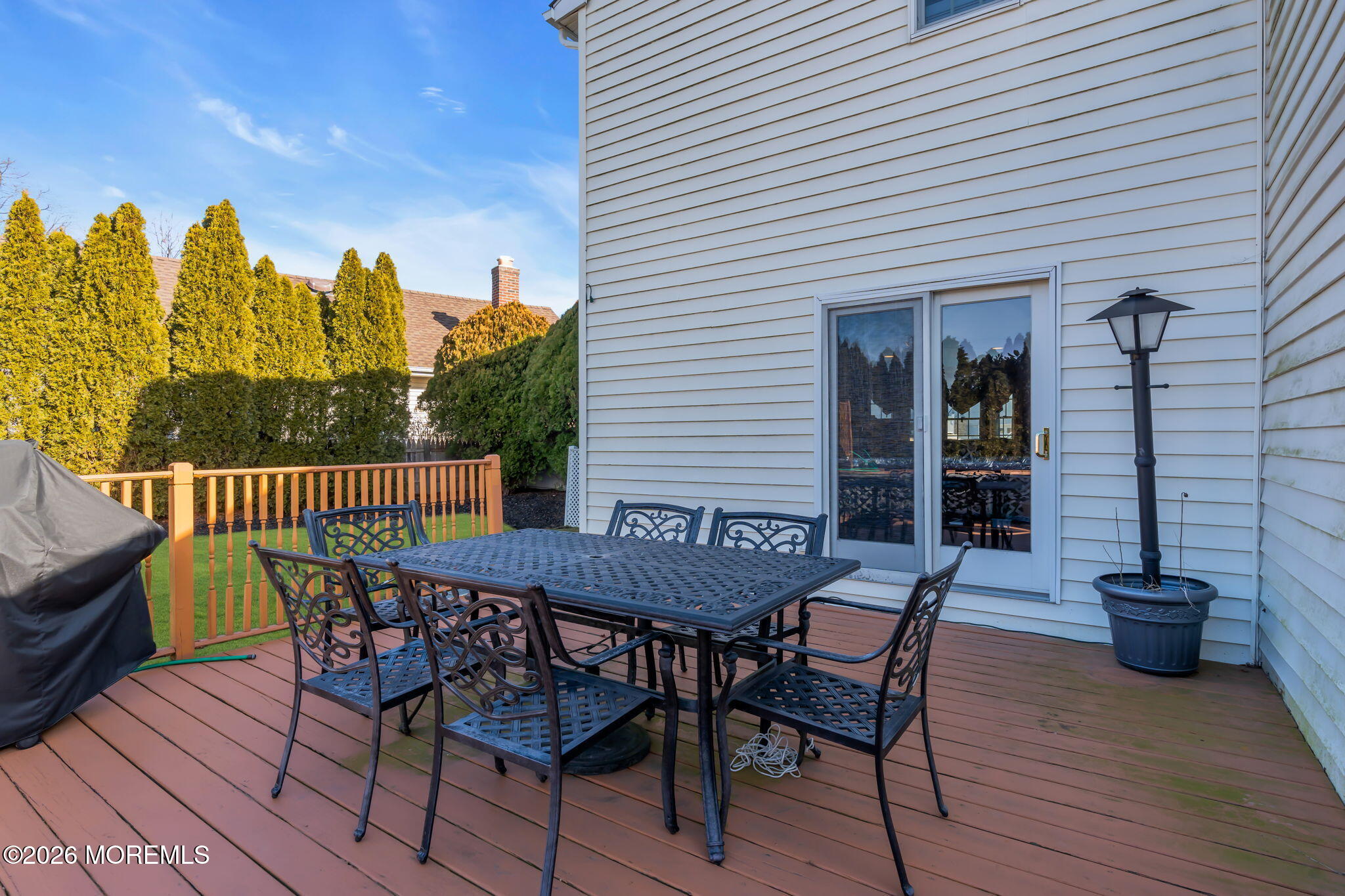83 Seawood Drive Keyport, NJ 07735 - Photo 22 of 23 a view of a roof deck with table and chairs and wooden floor
