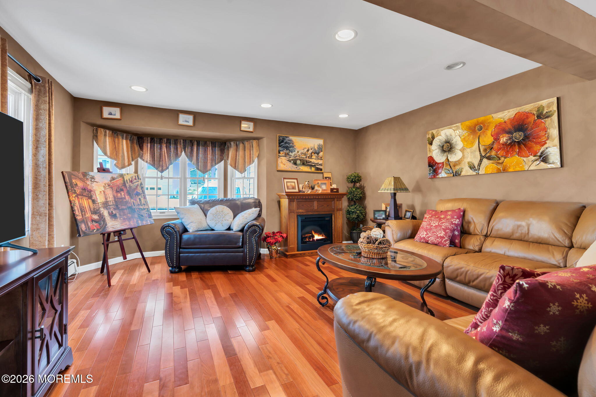 83 Seawood Drive Keyport, NJ 07735 - Photo 8 of 23 a living room with furniture a fireplace and a flat screen tv