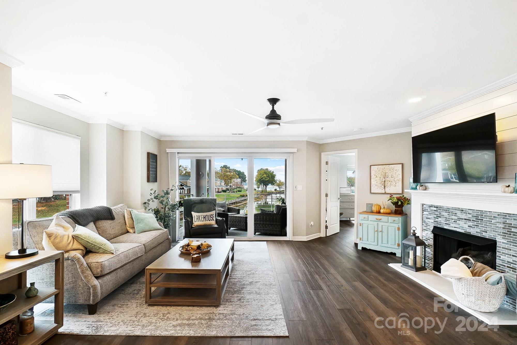 18621 Harborside Drive Cornelius, NC 28031 - Photo 12 of 33 a living room with furniture a flat screen tv and a fireplace