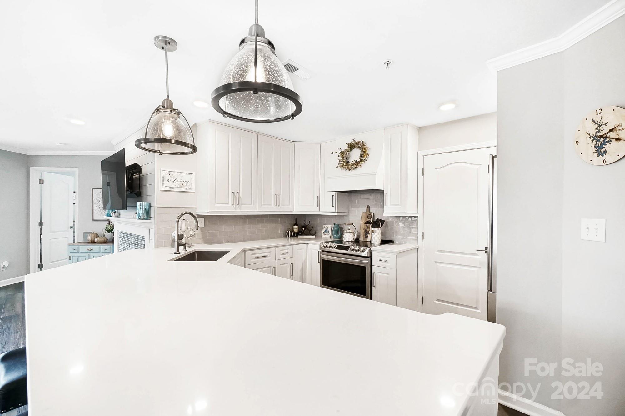 18621 Harborside Drive Cornelius, NC 28031 - Photo 13 of 33 a kitchen with stainless steel appliances a sink stove and refrigerator
