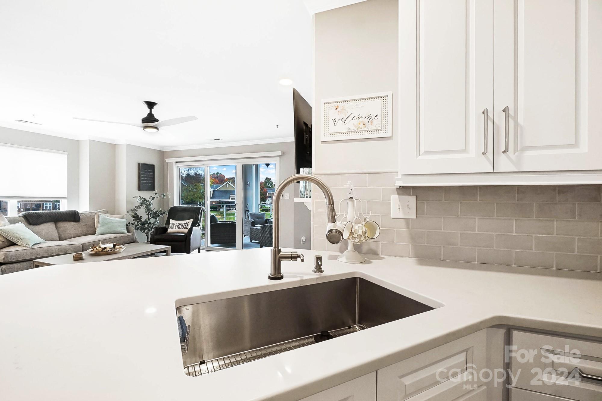 18621 Harborside Drive Cornelius, NC 28031 - Photo 14 of 33 a kitchen with a sink and a stove with cabinets