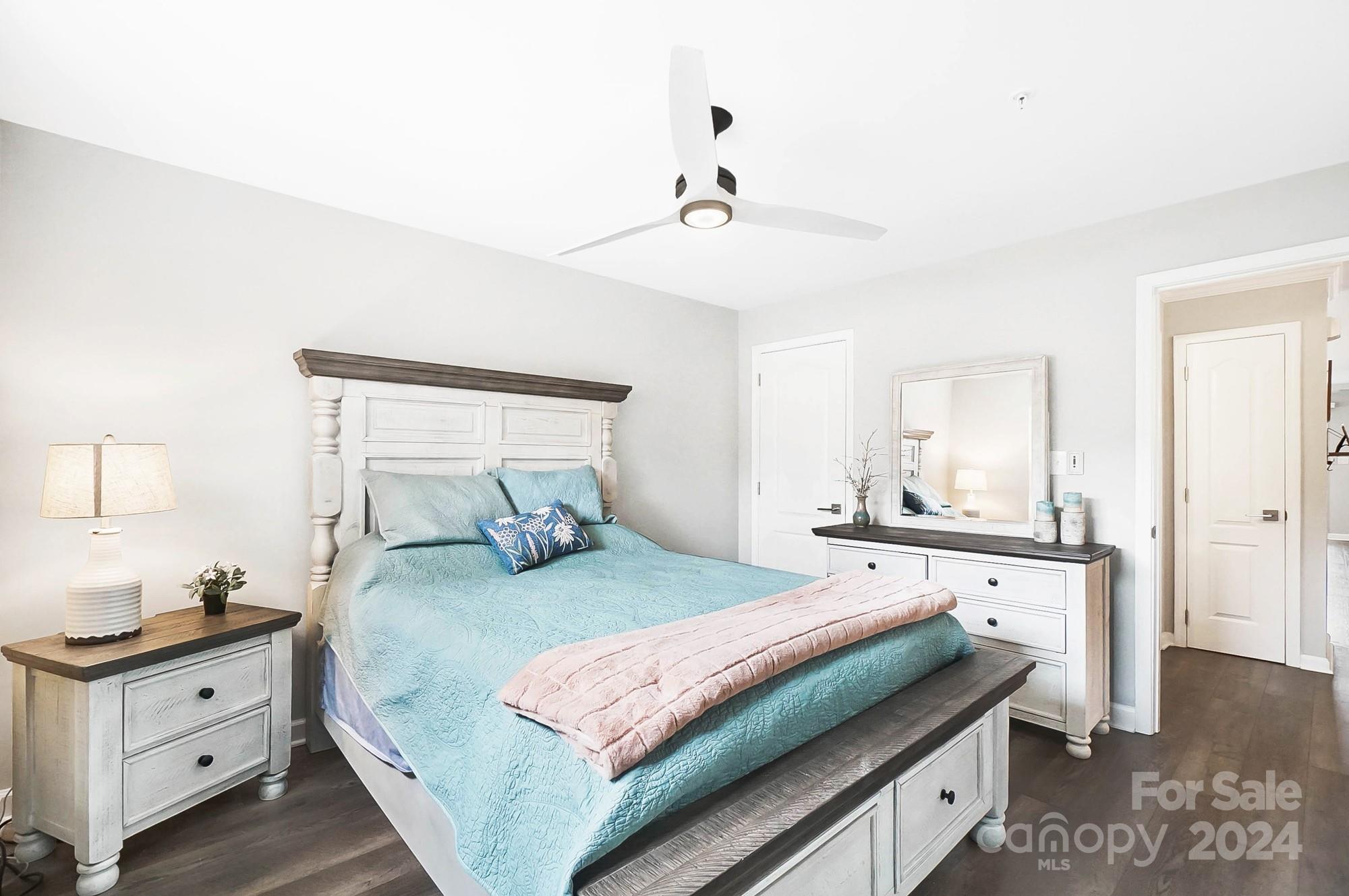 18621 Harborside Drive Cornelius, NC 28031 - Photo 15 of 33 a bedroom with a large bed and a chandelier