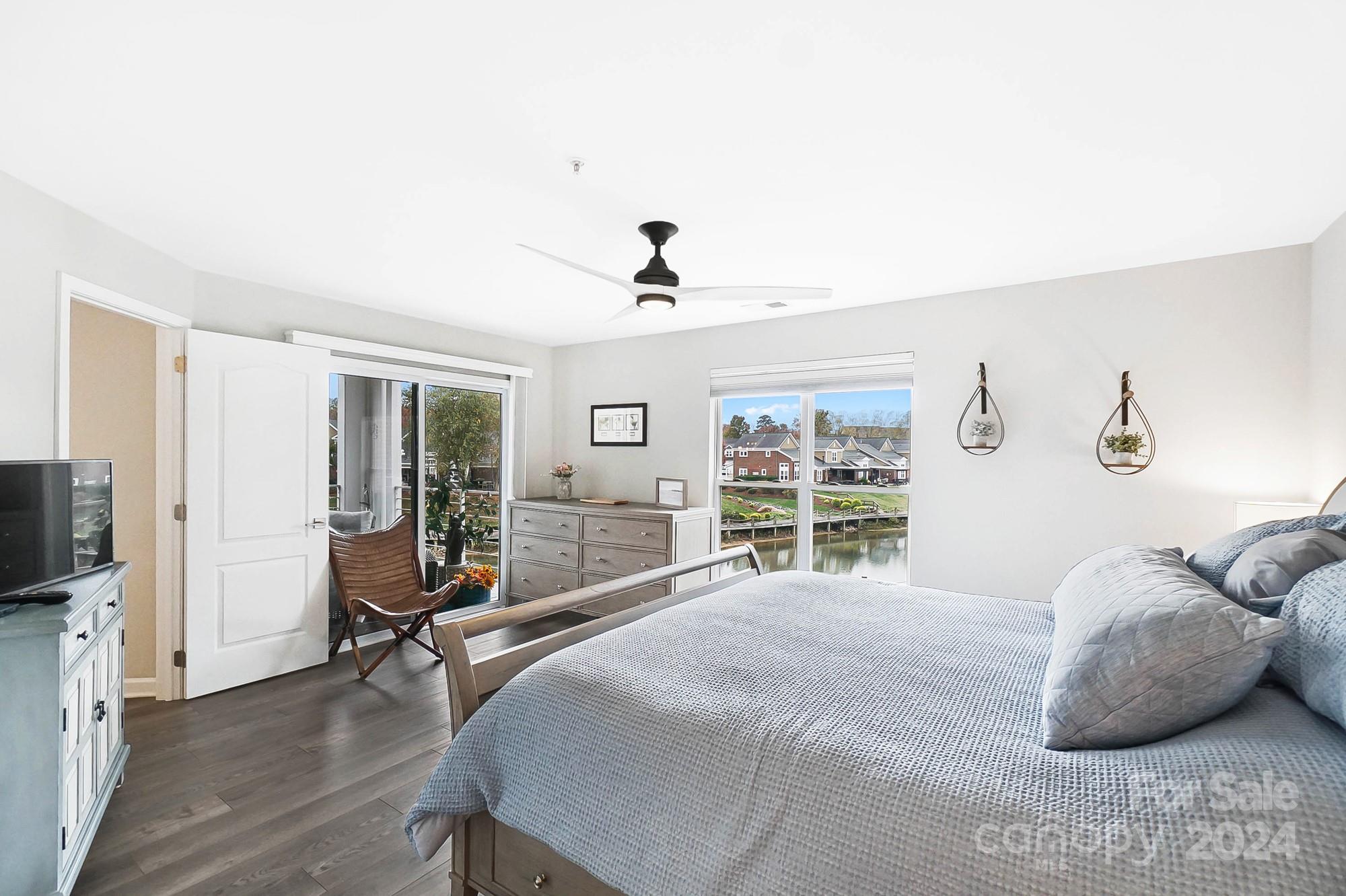 18621 Harborside Drive Cornelius, NC 28031 - Photo 21 of 33 a bedroom with a bed and a flat tv screen on the dresser