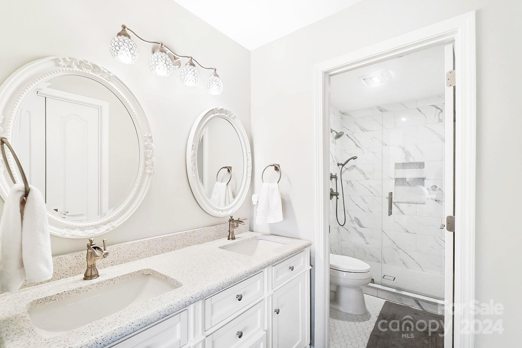 18621 Harborside Drive Cornelius, NC 28031 - Photo 22 of 33 a bathroom with a granite countertop sink a toilet and a mirror