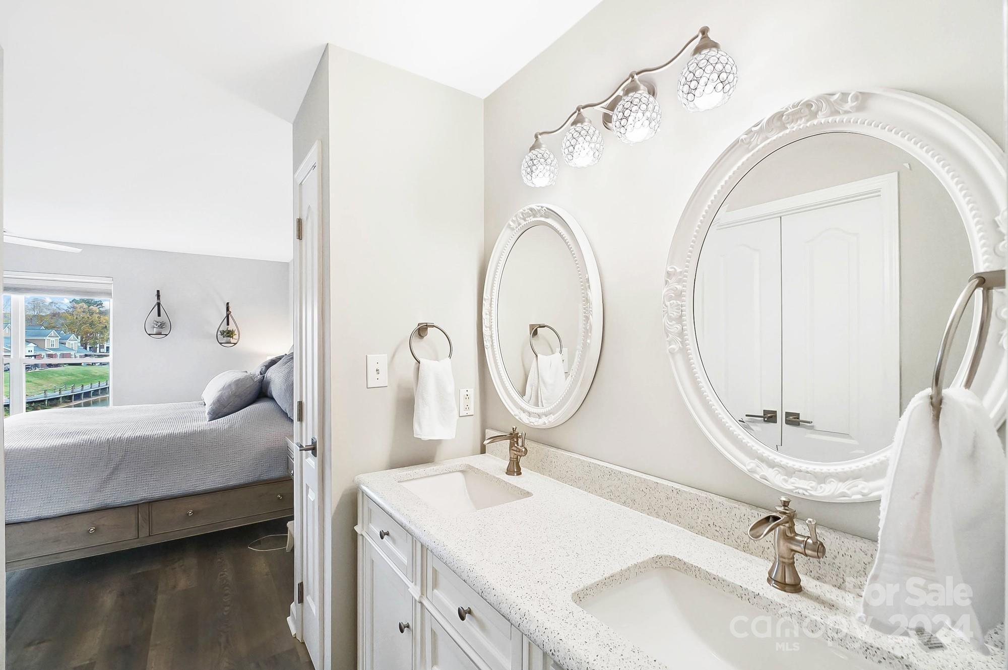 18621 Harborside Drive Cornelius, NC 28031 - Photo 25 of 33 a bathroom with a double vanity sink and a mirror