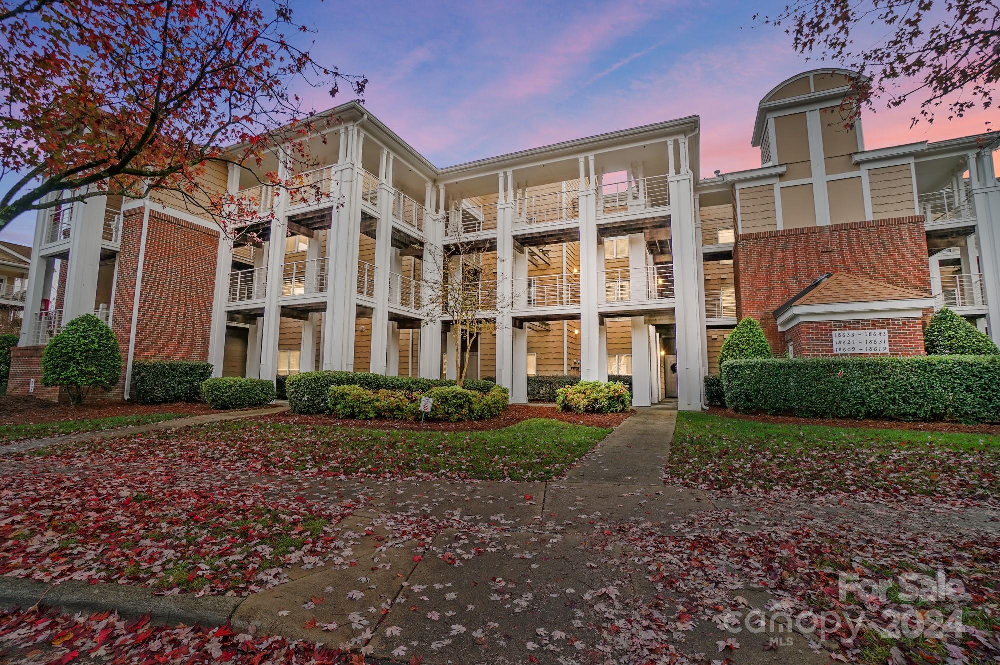18621 Harborside Drive Cornelius, NC 28031 - Photo 28 of 33 a view of a brick building next to a yard