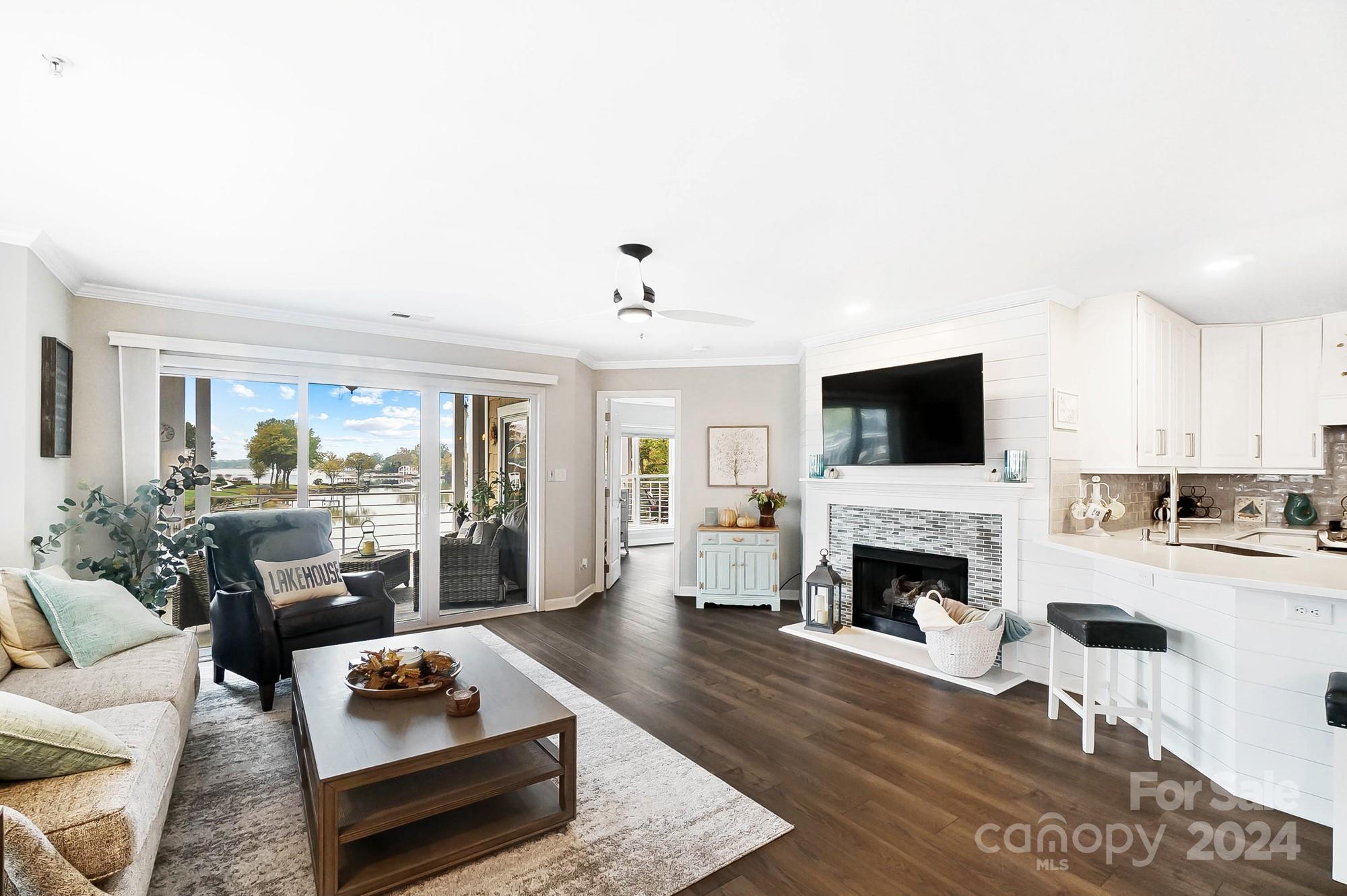 18621 Harborside Drive Cornelius, NC 28031 - Photo 4 of 33 a living room with furniture flat screen tv and a fireplace