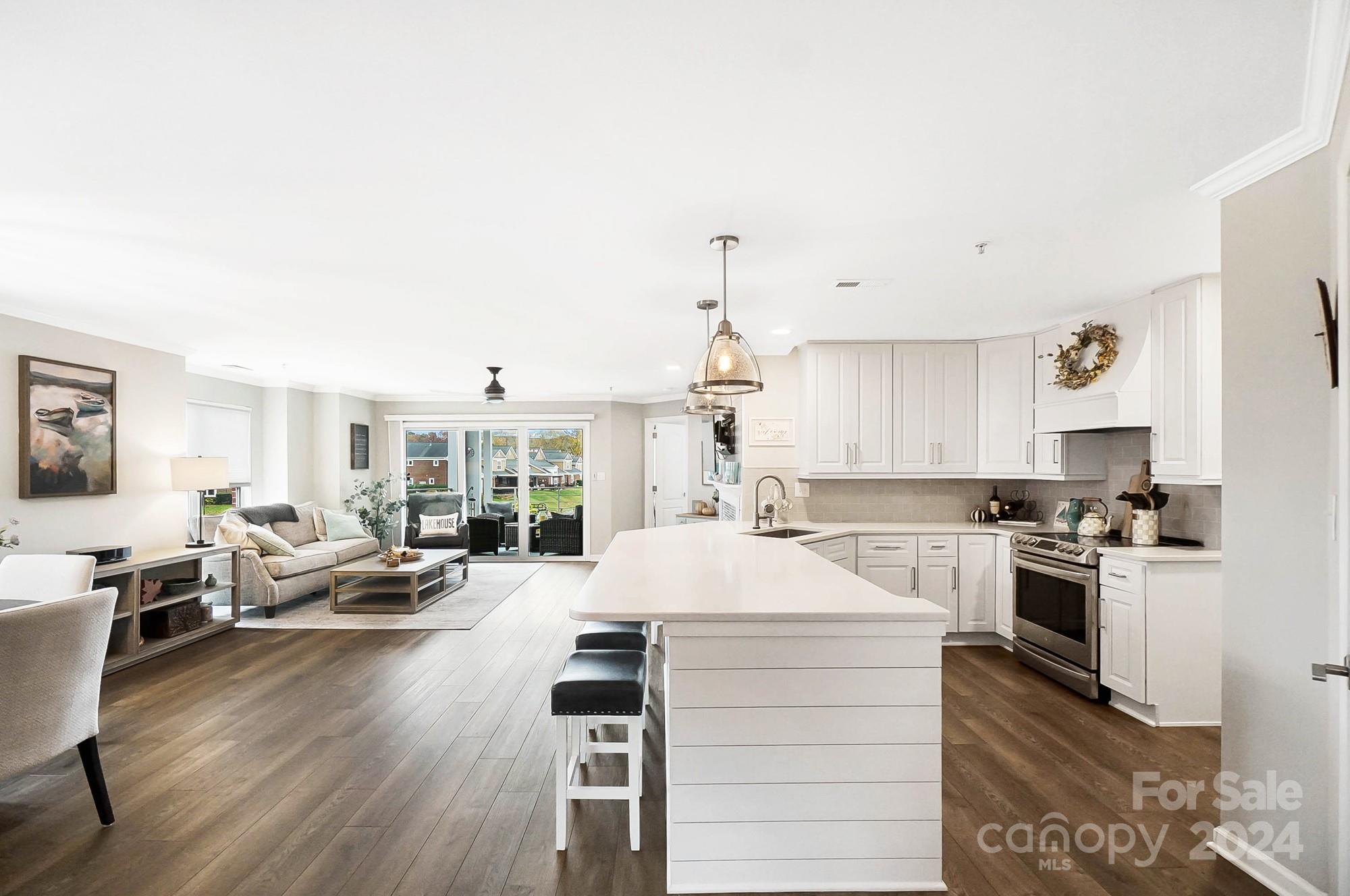 18621 Harborside Drive Cornelius, NC 28031 - Photo 7 of 33 a open kitchen with sink cabinets and wooden floor