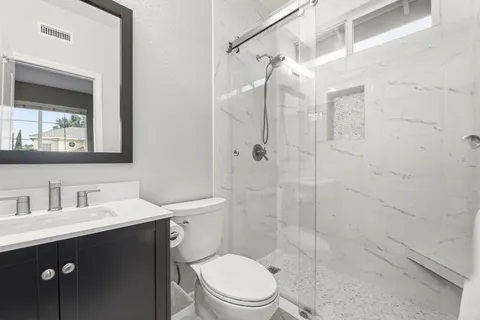 a view of a workspace with furniture and a potted plant