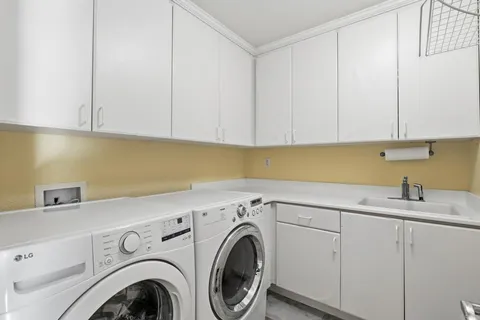 a view of a house with a yard and potted plants