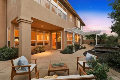 a view of a patio with table and chairs and potted plants