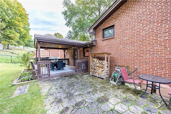 a view of a porch with furniture and wooden floor