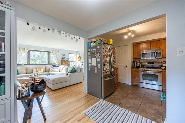 a living room with furniture and a kitchen