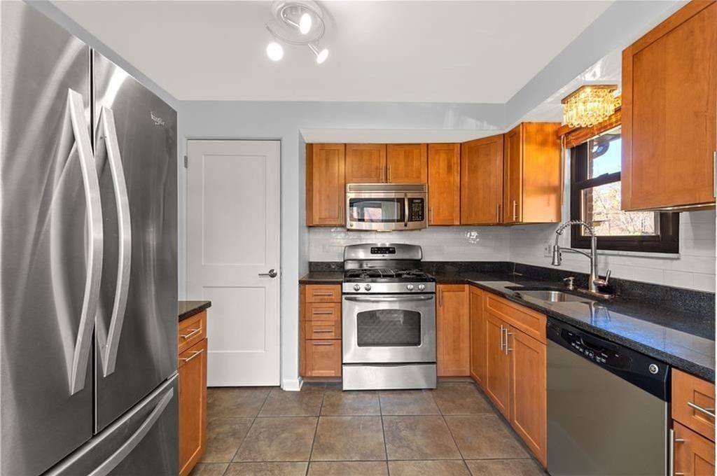 624 Fort Couch Road Pittsburgh, PA 15241 - Photo 10 of 32 a kitchen with stainless steel appliances granite countertop a refrigerator a stove a sink and a microwave