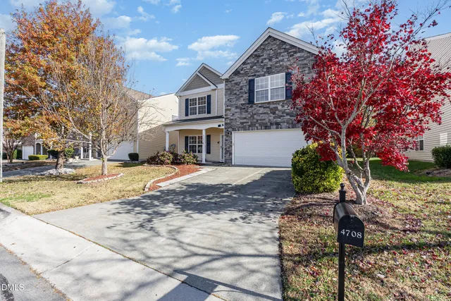a view of a white house with a yard covered with snow