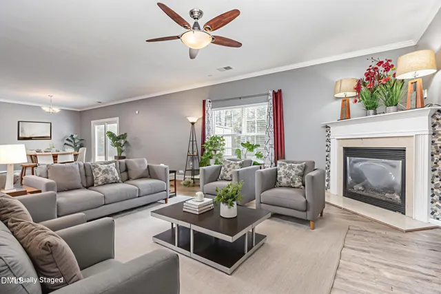 a living room with furniture a window and a fireplace