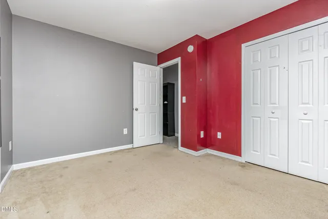 an empty room with closet area