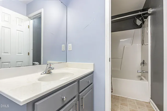 a bathroom with a sink vanity tub and shower