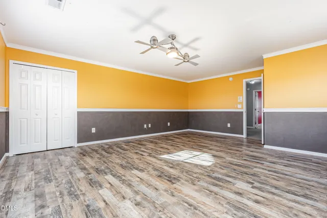 a view of a room with a ceiling fan